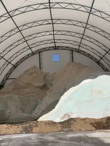 Massive piles of grit under an arching canopy.